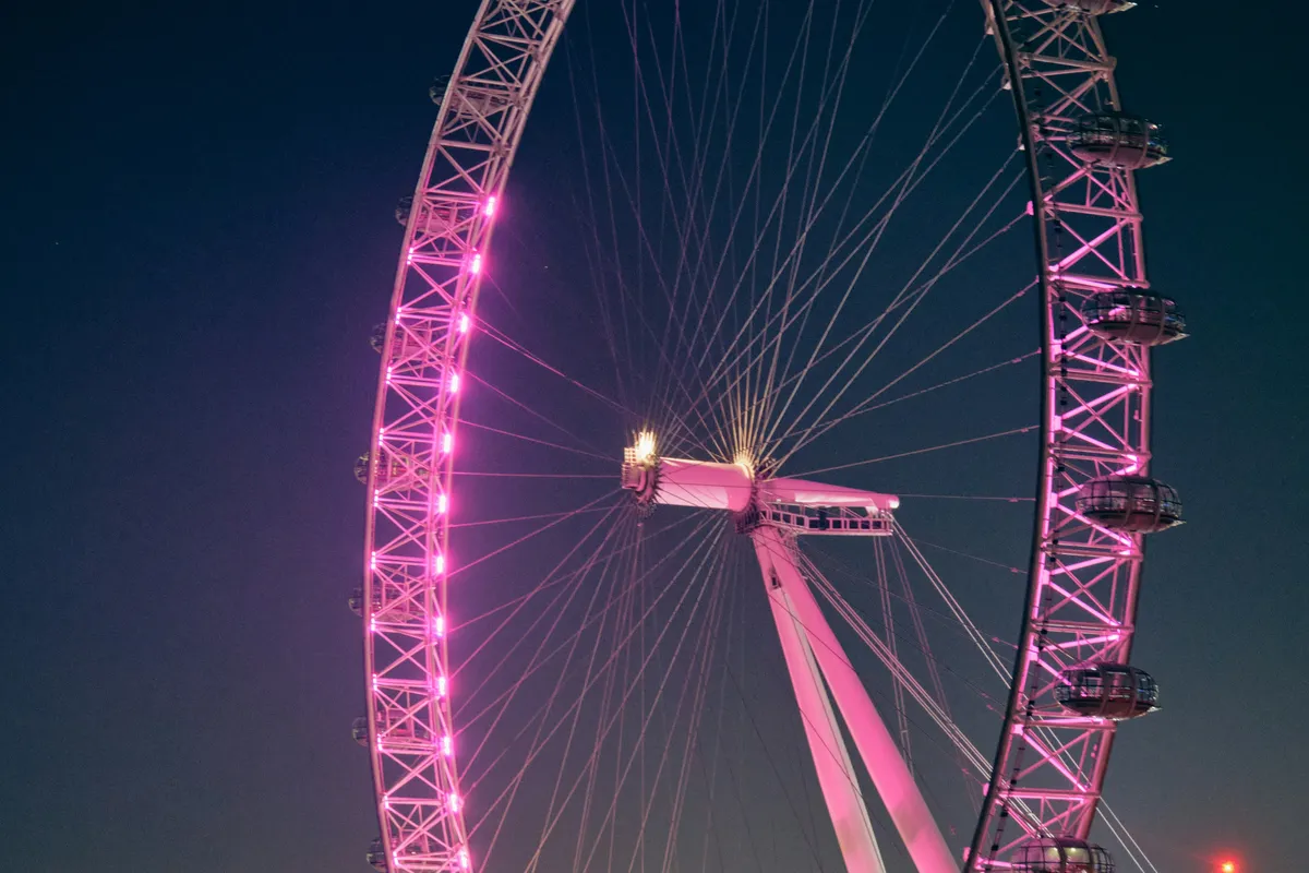 Illuminated Ferris wheel at night